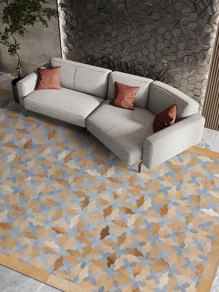 Tessera patchwork cowhide rug beneath a curved sofa